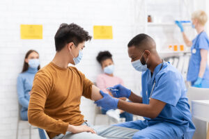 Doctor giving vaccination to a patient